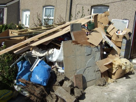 Sorted recycling bins and collection vehicles used by a house clearance service
